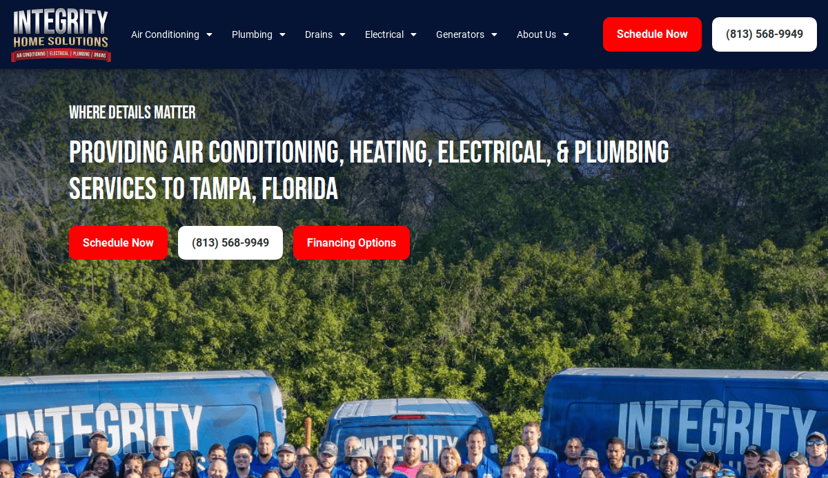 A group of Integrity Home Solutions employees stands in front of blue company vans. The website promotes air conditioning, heating, electrical, and plumbing services in Tampa, Florida, with bold text and red action buttons.