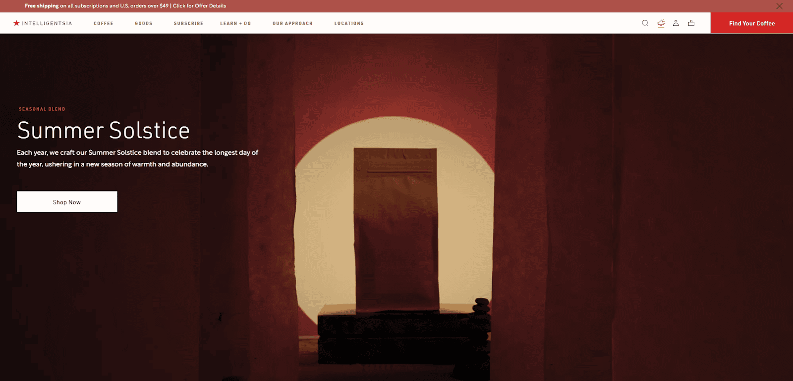 A coffee bag stands on a platform in a warmly lit archway surrounded by shadows, with text promoting a Summer Solstice seasonal blend and a Shop Now button on the left.