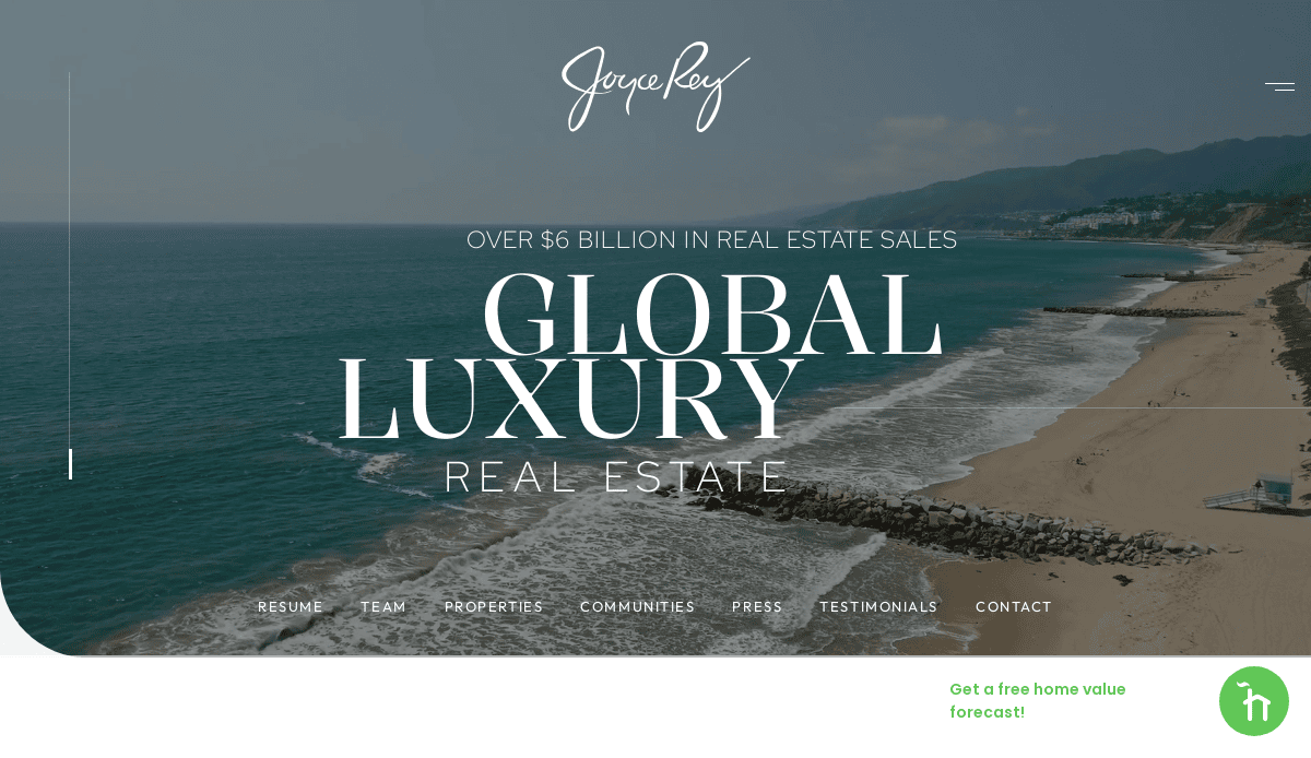 Aerial view of a beach with mountains in the background and ocean waves. Overlaid text reads “Over $6 Billion in Real Estate Sales. Global Luxury Real Estate.” Navigation links appear at the bottom.