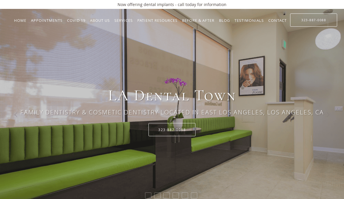 Modern dental office waiting area with green cushioned benches, large windows with blinds, a framed poster on the wall, and a reception counter. Text overlay reads LA Dental Town and contact information.
