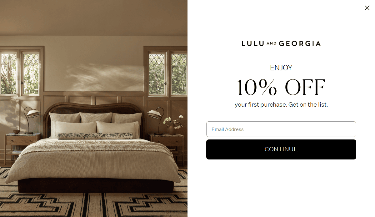 A cozy bedroom with a neatly made bed, two bedside tables with lamps, and windows letting in natural light. Beside it, a promotional message offers 10% off a first purchase for joining Lulu and Georgia’s email list.
