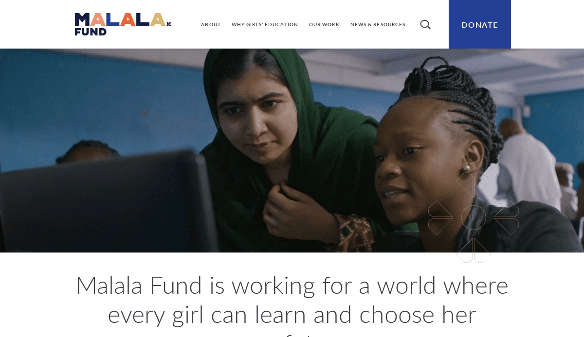 Two young women, one wearing a green headscarf, look intently at a laptop screen together in a classroom setting. The Malala Fund website header and navigation bar are visible above.