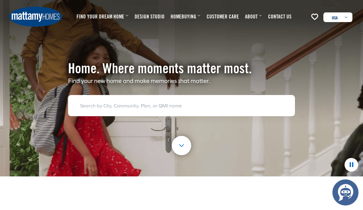 A young girl in a red dress playfully slides down a white staircase railing while an adult in a yellow shirt stands behind her; text reads, Home. Where moments matter most. with a home search bar below.