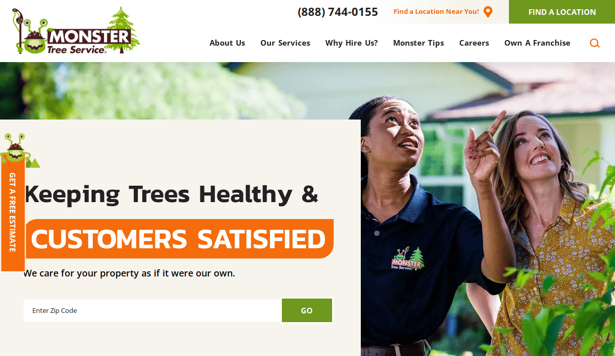 Two women stand outdoors under trees; one in a Monster Tree Service uniform gestures upward while the other smiles. A website banner says, Keeping Trees Healthy & Customers Satisfied. A zip code entry form is visible.