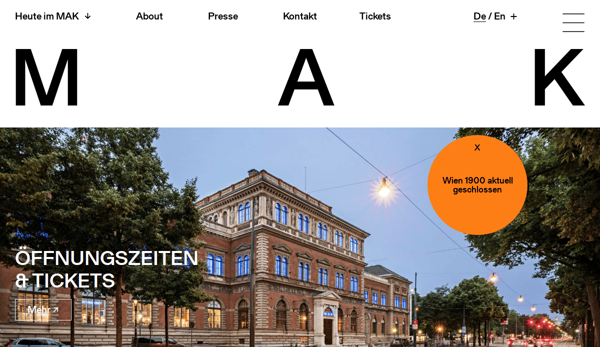 Screenshot of the MAK museum website showing a photo of the museum’s historic building at dusk, with Öffnungszeiten & Tickets text and an orange notice saying Wien 1900 aktuell geschlossen.