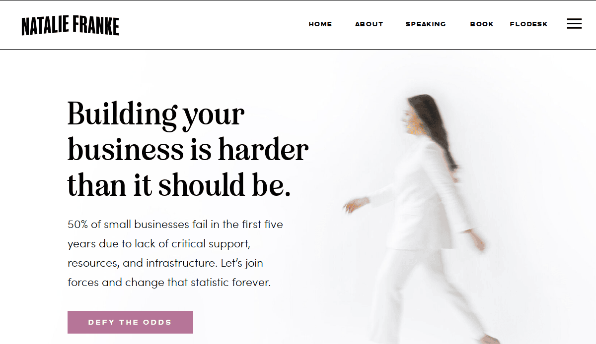 A woman in white walks across a white background next to text that reads: Building your business is harder than it should be. Additional text describes small business challenges and includes a pink button labeled Defy the odds.