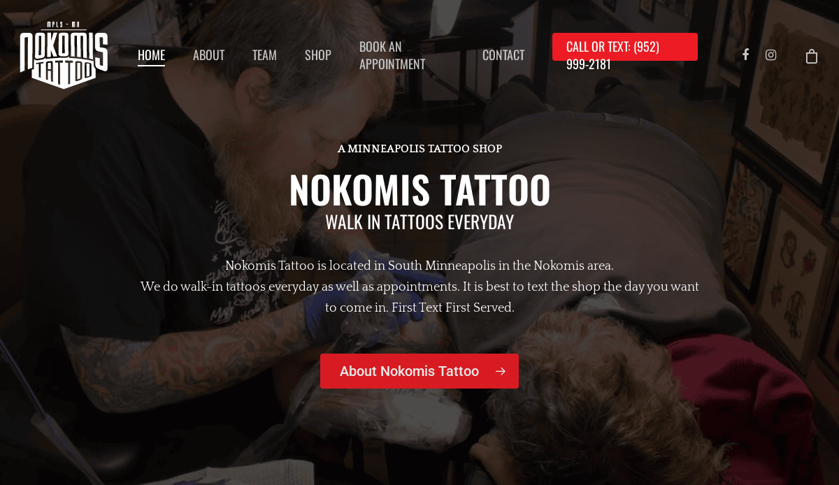 Two tattoo artists working on a client in a dimly lit tattoo shop. Text overlay promotes Nokomis Tattoo in Minneapolis, emphasizing walk-ins and providing contact and appointment information.