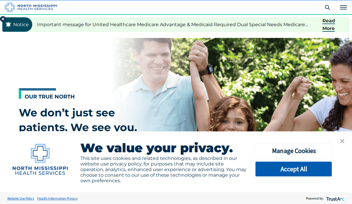 A family smiles outdoors, with a man and woman holding a childs hands. Text overlays say, We don’t just see patients. We see you, and display privacy and cookie management options for North Mississippi Health Services.