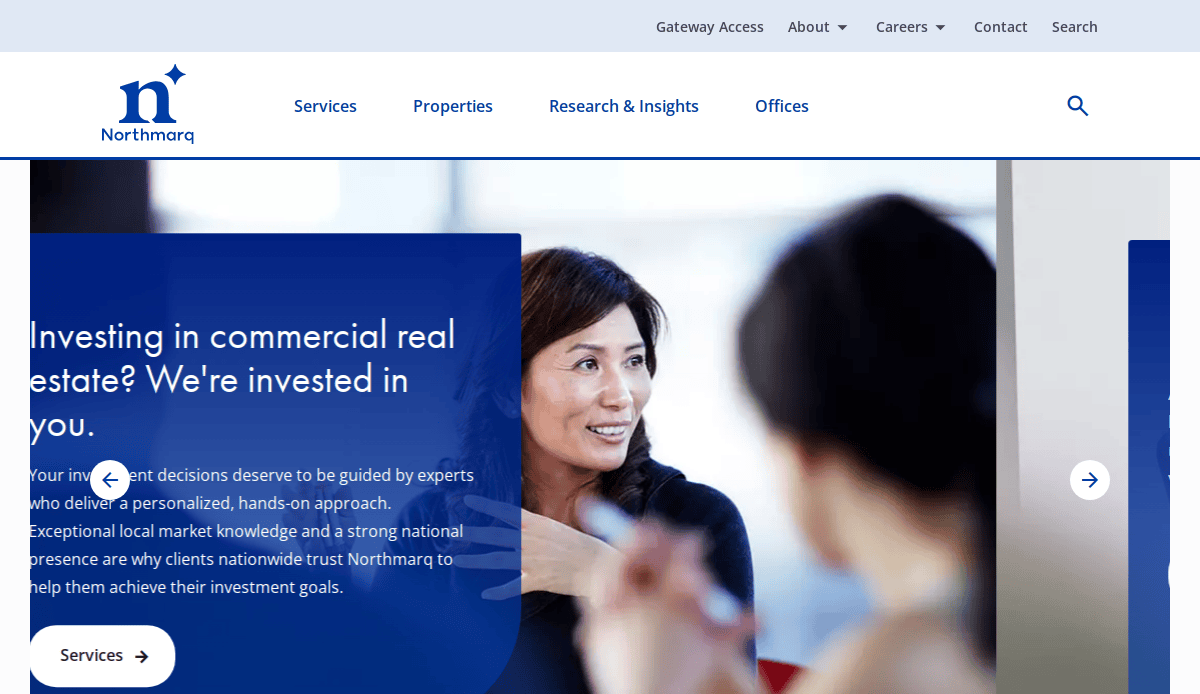 Homepage of Northmarq’s website featuring a banner with a professional woman talking in a business setting. The text overlay reads, “Investing in commercial real estate? We’re invested in you.” Navigation menu is visible at the top.