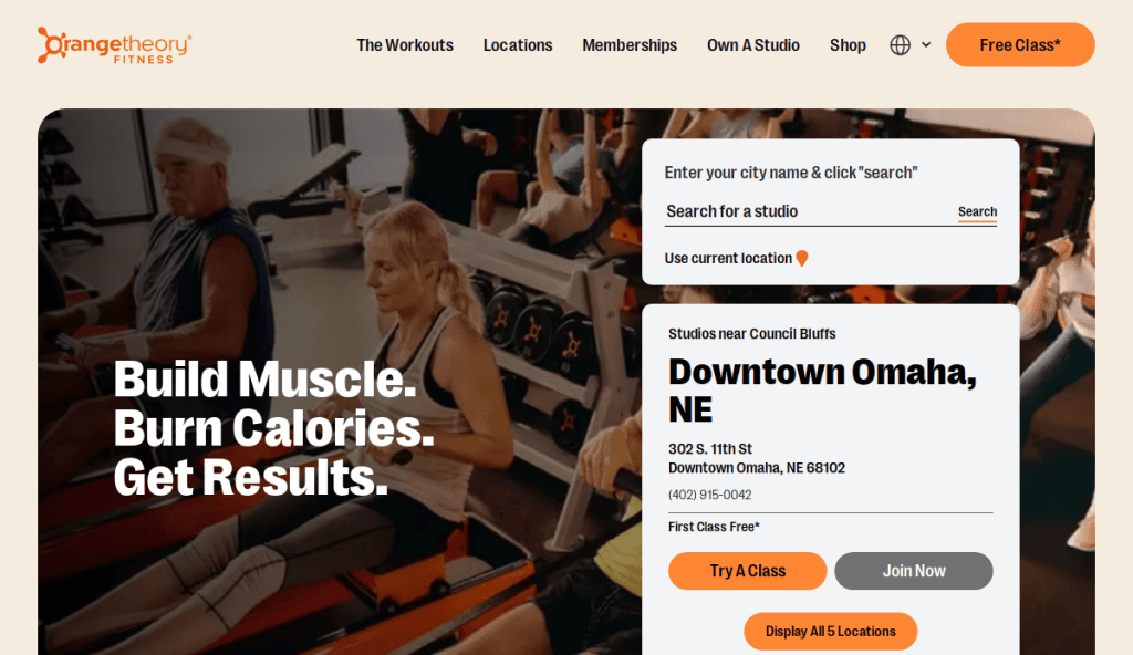 A group of people exercise on rowing machines in a gym studio. The text reads, Build Muscle. Burn Calories. Get Results. An online form offers studio search options for Orangetheory Fitness in Downtown Omaha, NE.