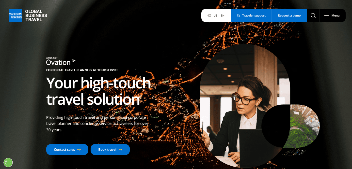 A businesswoman wearing glasses works at a desk with a laptop and notepad. The background shows an aerial night view of a city lit with orange lights. Text reads, Your high-performing site for travel agency website design.