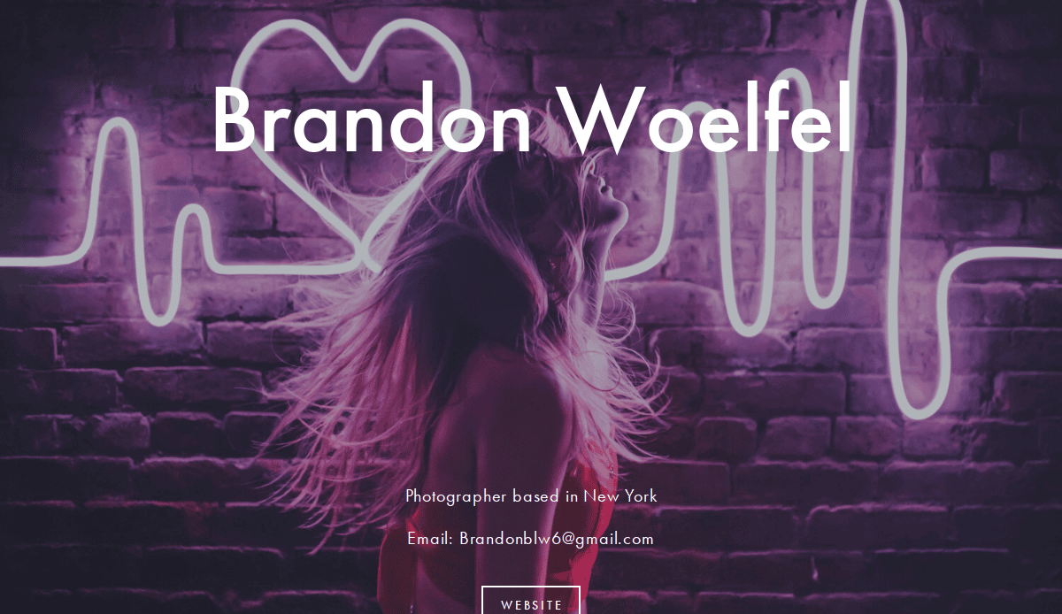 A person with long hair stands in front of a brick wall lit by pink neon heart and waveform lights. Text reads “Brandon Woelfel,” showcasing best examples of photography website design, with photographer details and a website button below.