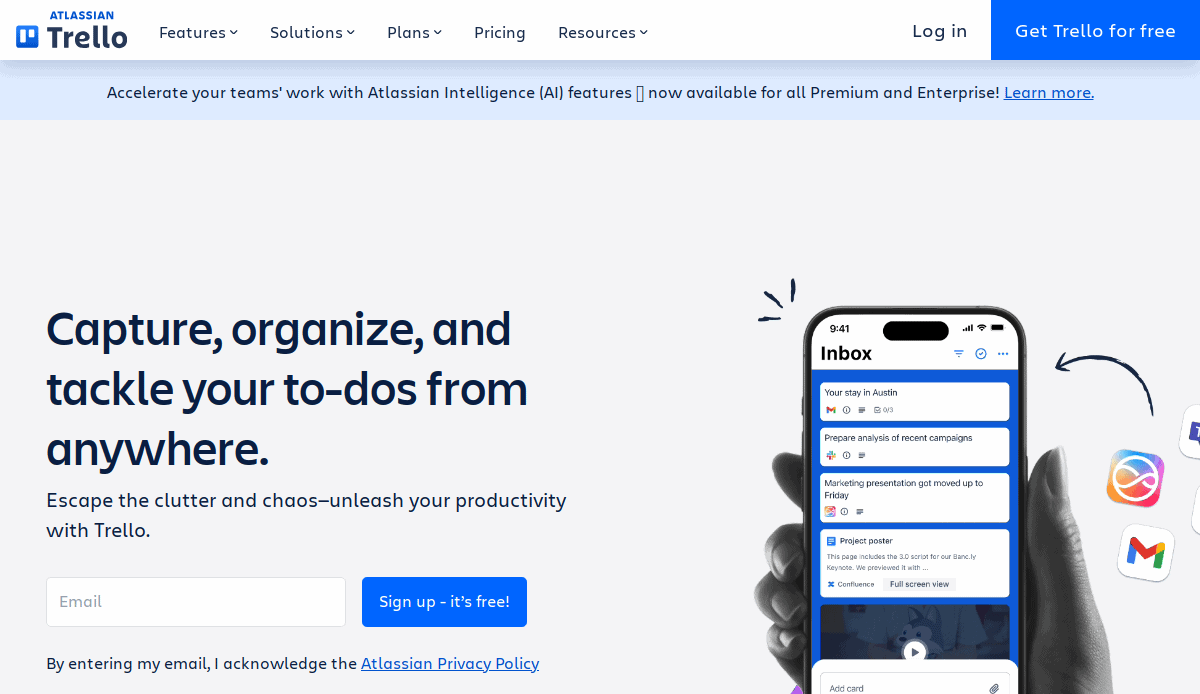 Screenshot of Trello’s homepage showing a sign-up form, a slogan: Capture, organize, and tackle your to-dos from anywhere, and a hand holding a phone with the Trello app open, surrounded by app icons.