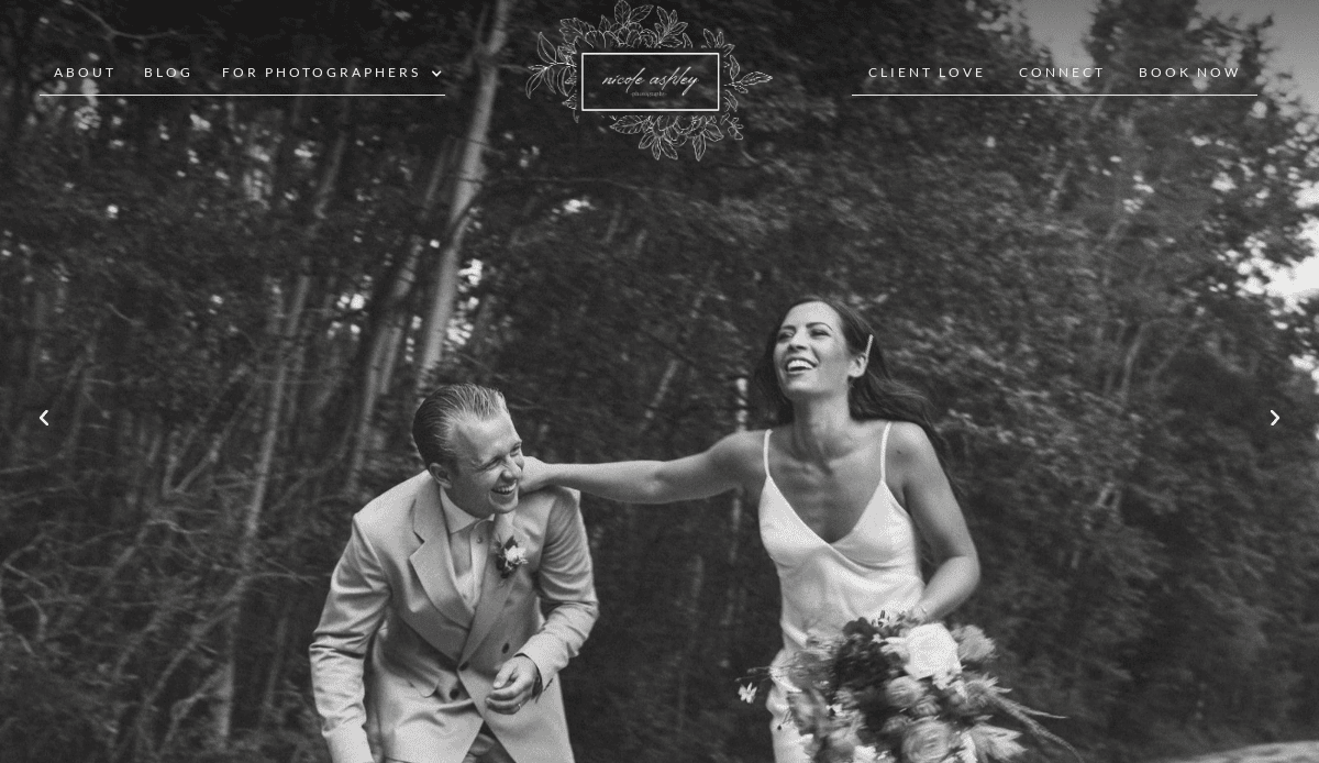 Black and white photo of a bride and groom laughing joyfully outdoors, the bride holding a bouquet, with trees in the background. Website navigation and floral logo appear at the top, offering inspiration for stunning photography website design.