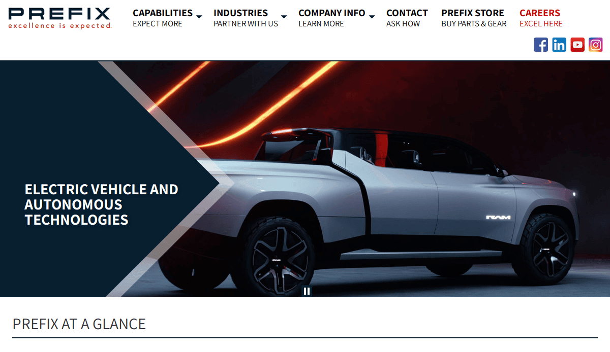 A futuristic silver electric pickup truck with angular design is displayed in a dark showroom with red and orange lights. Text reads Electric Vehicle and Autonomous Technologies.