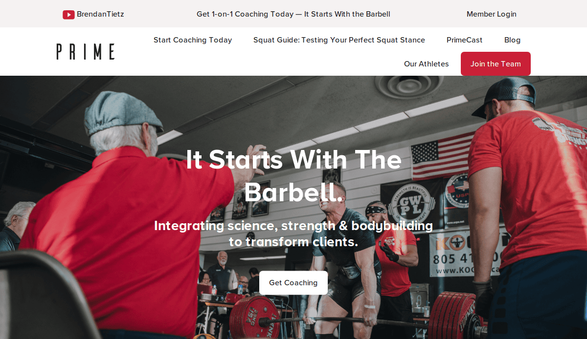 A powerlifting coach instructs an athlete lifting a heavy barbell in a gym with spectators watching; bold text reads, “It Starts With The Barbell,” with navigation links at the top and a “Get Coaching” button.