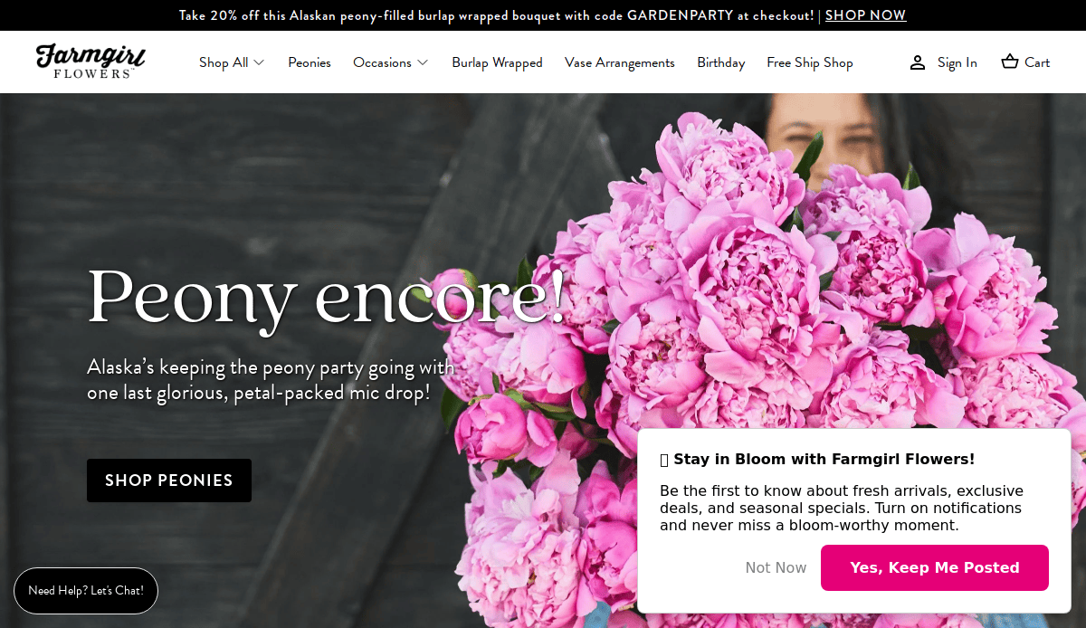 A woman holds a large, vibrant bouquet of pink peonies in front of a dark wooden wall. The Farmgirl Flowers website is displayed, featuring a peony promotion and a pop-up to stay updated on floral news.