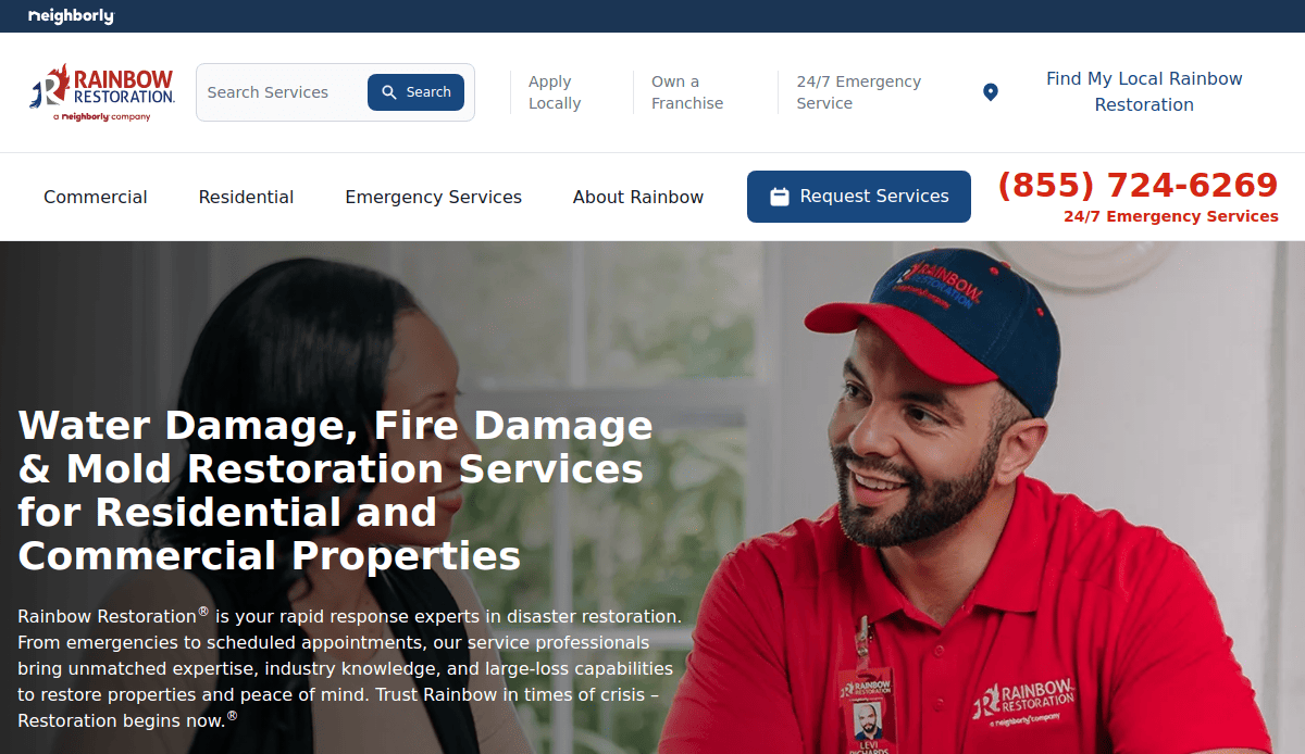 A Rainbow Restoration employee in uniform talks with a smiling woman. The website promotes water, fire, and mold restoration services for residential and commercial properties. A phone number for emergency services is displayed.