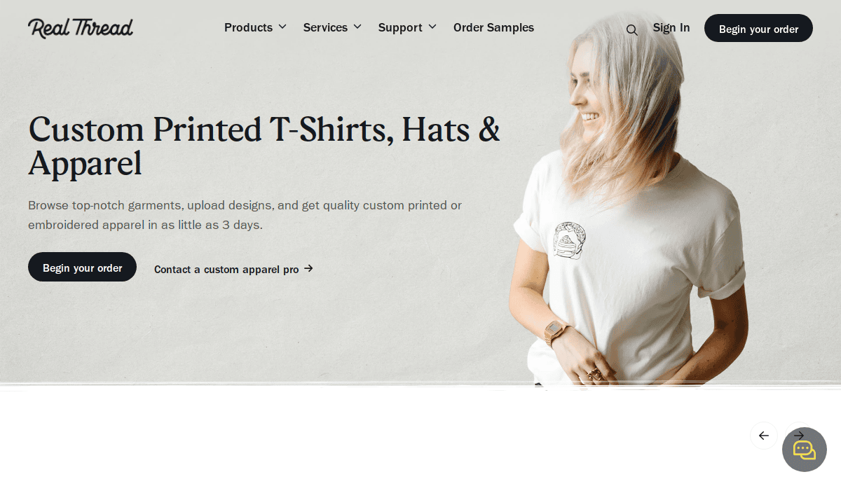 A woman wearing a white t-shirt with a small printed design smiles and looks to her right. The website header reads Custom Printed T-Shirts, Hats & Apparel with options to begin an order.