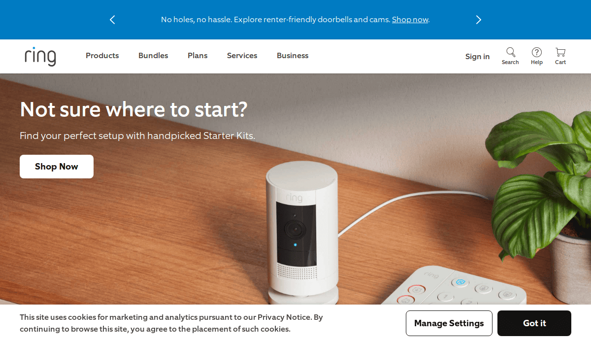 A Ring security camera sits on a table next to a remote and a plant. The text reads Not sure where to start? Find your perfect setup with handpicked Starter Kits. Buttons for Shop Now and cookie settings are visible.