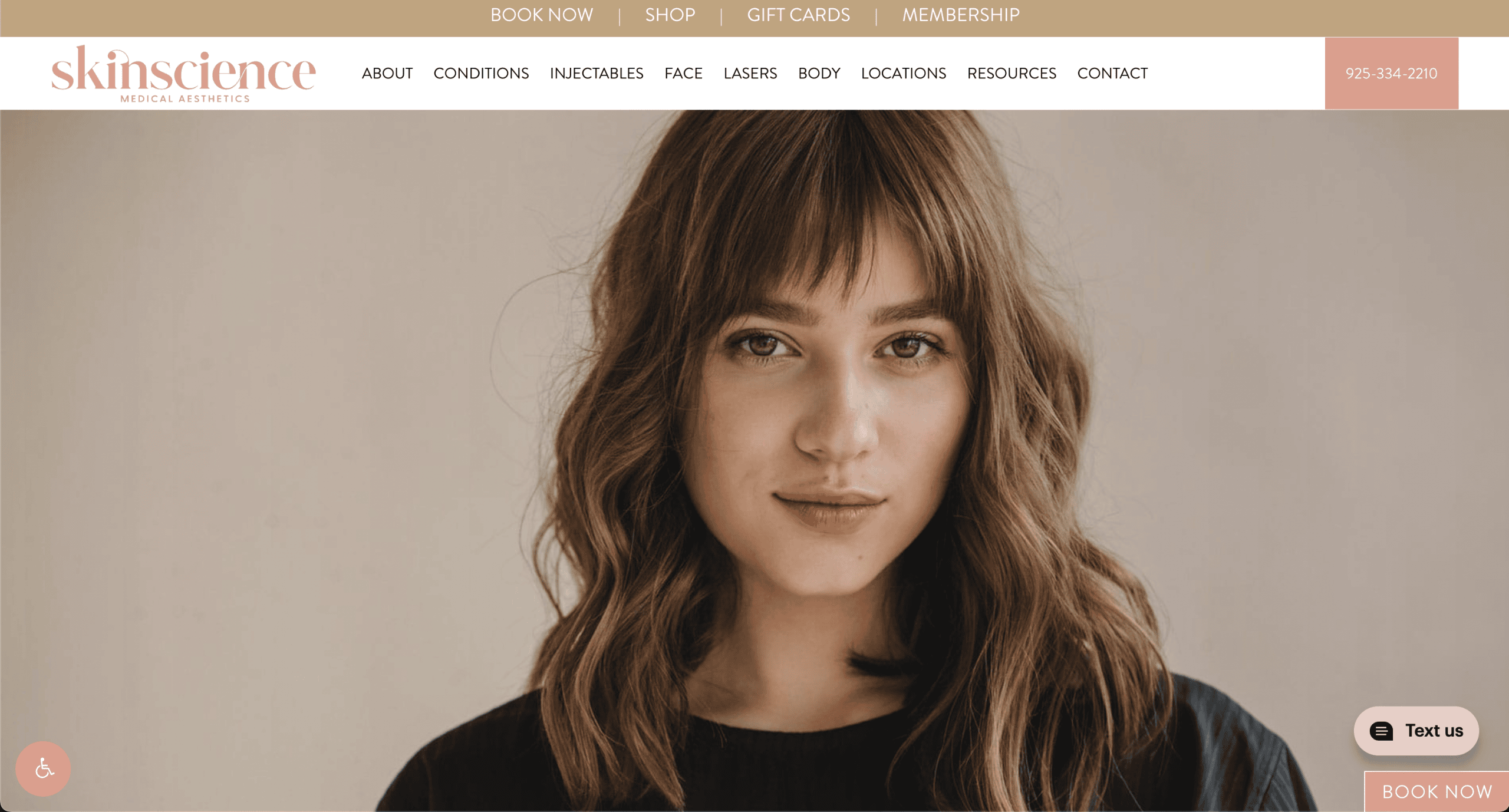 A young woman with wavy, light brown hair and bangs is looking at the camera. The website header reads skinscience medical aesthetics with navigation links and a chat box in the lower right corner.