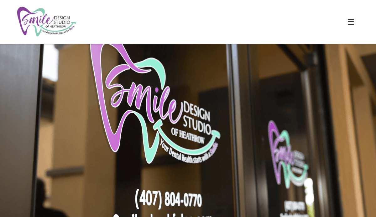 A glass door displays the Smile Design Studio of Heathrow logo, which features a tooth outline with stylized text in purple and teal, and contact information below.
