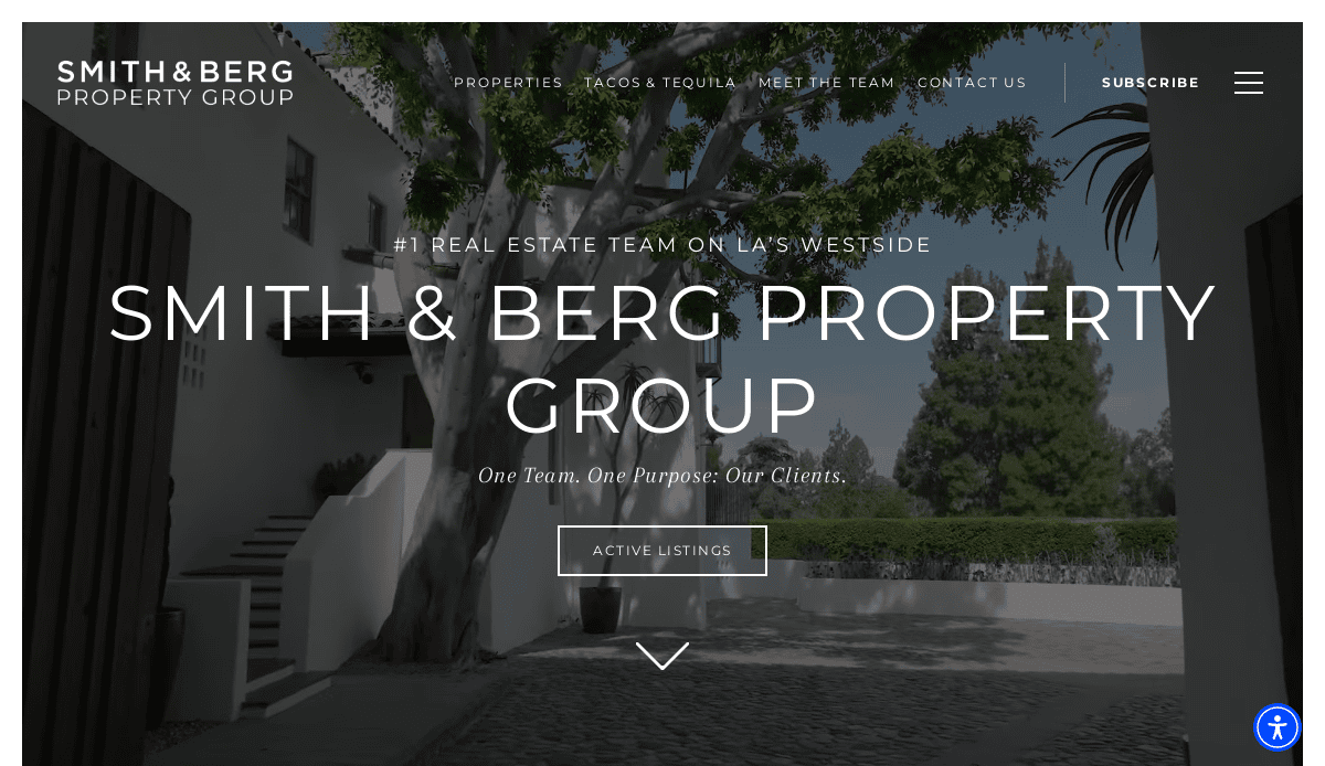 Homepage of Smith & Berg Property Group, featuring a large tree, a modern white building, and “#1 Real Estate Team on LA’s Westside” with options to view listings or navigate the website.