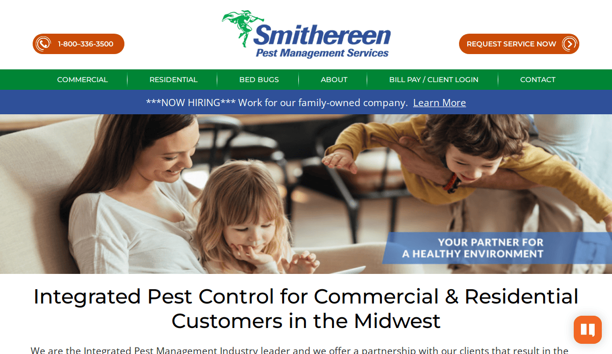 A smiling woman and two children sit on a sofa in a bright living room. The website banner reads “Smithereen Pest Management Services” with contact options and a recruitment notice at the top.