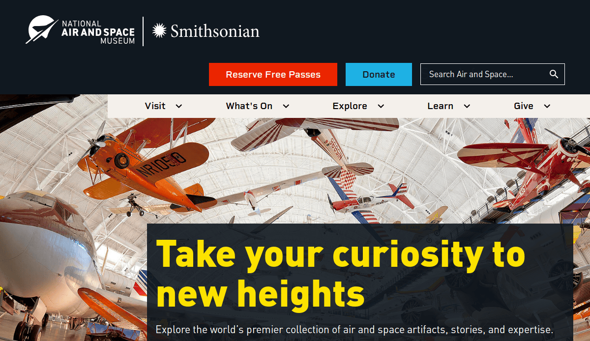 Homepage of the National Air and Space Museum, showing colorful vintage airplanes hanging from the ceiling and a banner reading, Take your curiosity to new heights.