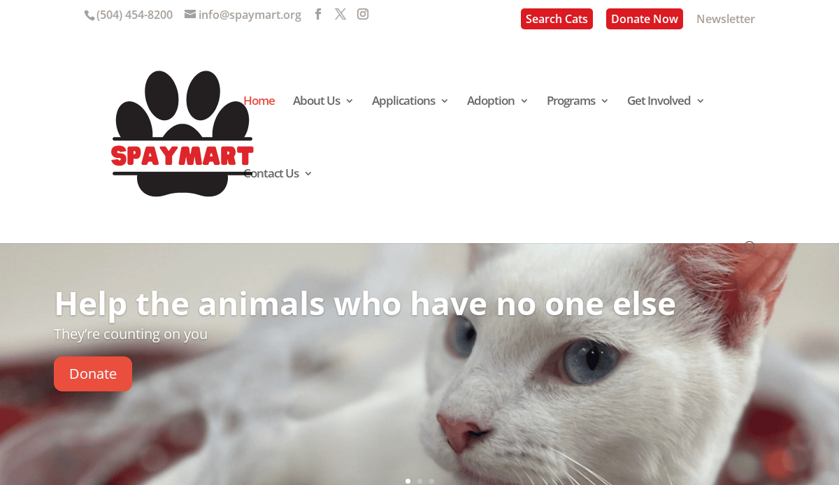 Screenshot of SpayMart’s website homepage showing a white cat with blue eyes, donation buttons, contact info, and navigation links for home, about, applications, adoption, programs, and getting involved.