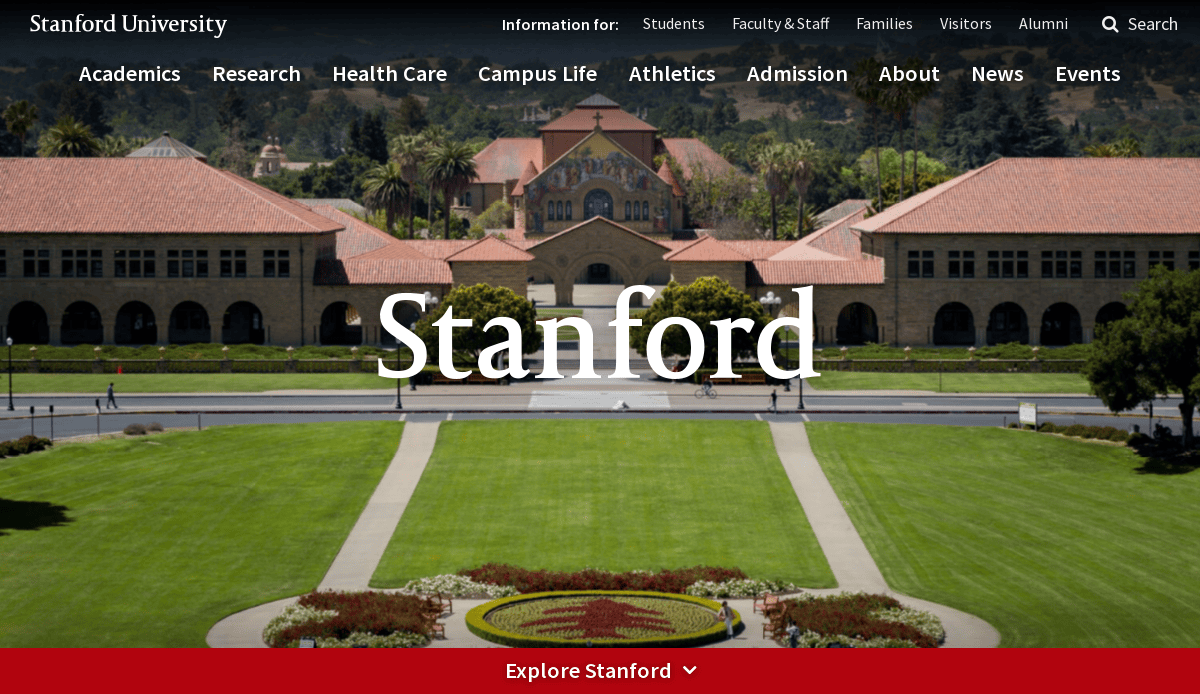 A view of Stanford University’s campus showing a large green lawn, red-roofed university buildings, palm trees, and the word Stanford overlaid in bold white text. Menu links appear at the top of the page.
