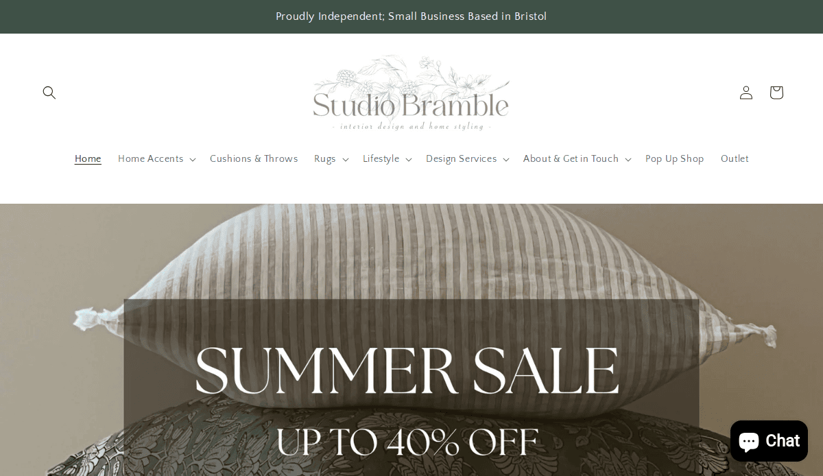 Website homepage for Studio Bramble, showing stacked striped cushions and a banner promoting a summer sale of up to 40% off. Menu options for home accents, cushions, rugs, lifestyle, and more are visible.
