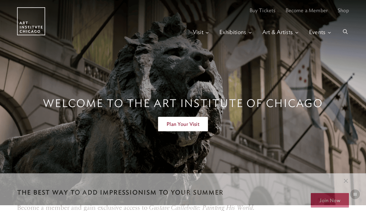 A close-up of a bronze lion statue in front of the Art Institute of Chicago, with banners on the building and a text overlay reading Welcome to the Art Institute of Chicago.