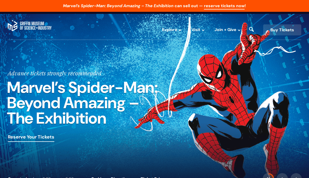 Website homepage for Marvel’s Spider-Man: Beyond Amazing exhibition. Features a dynamic illustration of Spider-Man swinging on a web against a blue background, with event details and call-to-action buttons.