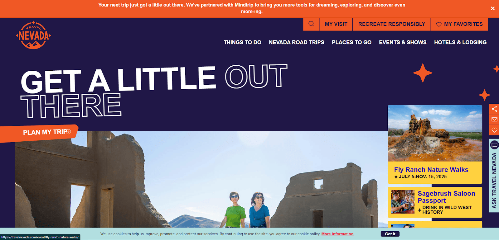 Two people stand among the ruins of a stone building under a blue sky. The text reads “Get a little out there.” Promotional banners and travel information are visible on the edges and top of the image.