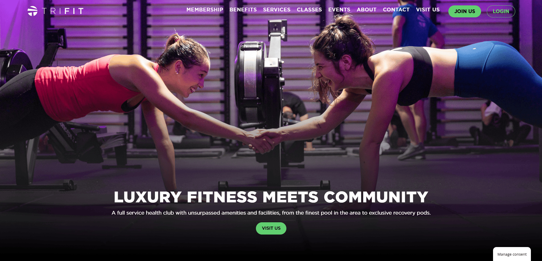 Two women in athletic wear smile and hold hands while doing planks at a gym, surrounded by fitness equipment and purple lighting. The text overlay reads, Luxury fitness meets community.