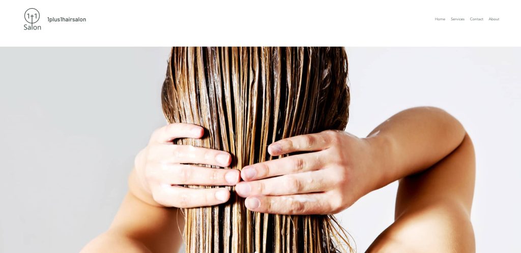 Close-up of a person with wet, medium-length hair running their fingers through it, seen from the back. The background is plain white, and the website header shows a salon logo and navigation menu.