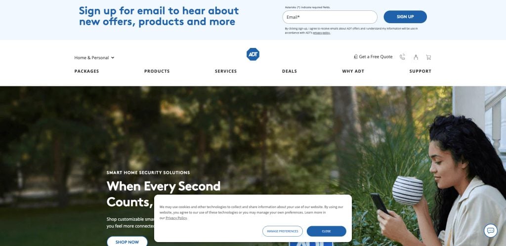 A woman with curly hair sits outside using her phone, featured on the ADT website. The page promotes signing up for email updates, and displays navigation options for packages, services, deals, and support.