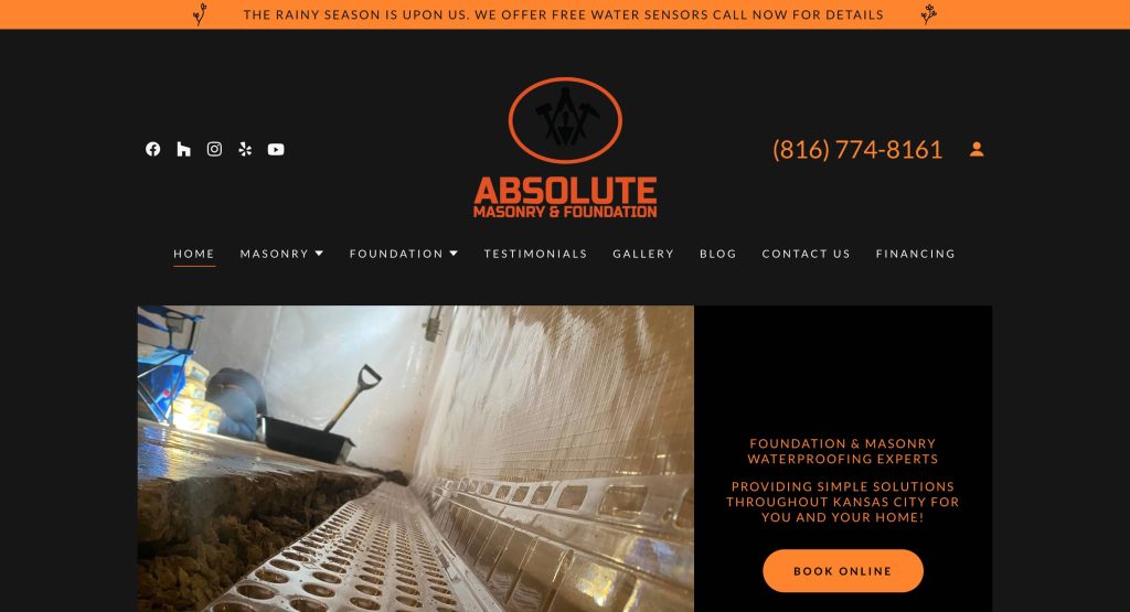 Website homepage for Absolute Masonry & Foundation, featuring their logo, contact number, navigation menu, and a photo of a basement waterproofing project with a shovel and drainage system visible.
