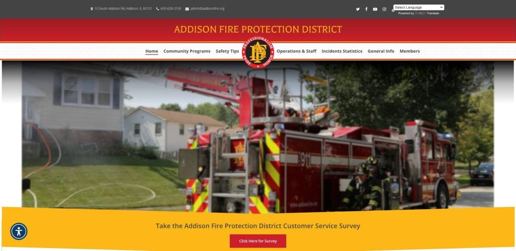 A fire truck is parked in front of a suburban house on the Addison Fire Protection District website homepage, with navigation links and a banner inviting users to take a customer service survey.