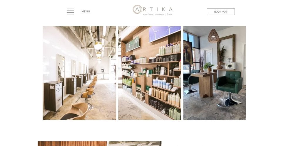 A modern hair salon with a row of styling chairs, shelves stocked with hair products, and a single green salon chair beside a large mirror in a stylish, well-lit interior.