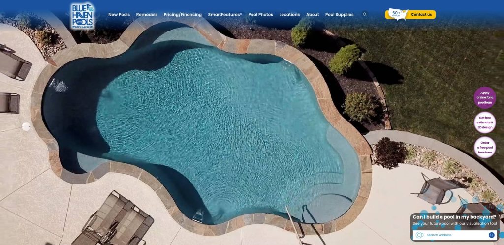 Aerial view of a backyard swimming pool with curved edges, surrounded by a stone deck, lounge chairs, and landscaped greenery. The website header features navigation links and the Blue Haven Pools logo.