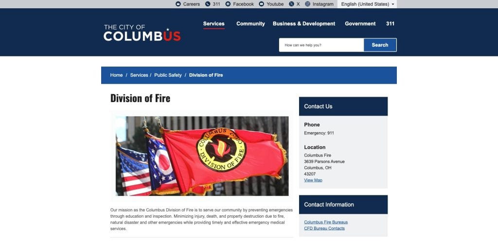 A red Columbus Division of Fire flag flies alongside the American and Ohio state flags in front of a building. The webpage header reads “City of Columbus” with menu options for government and services.