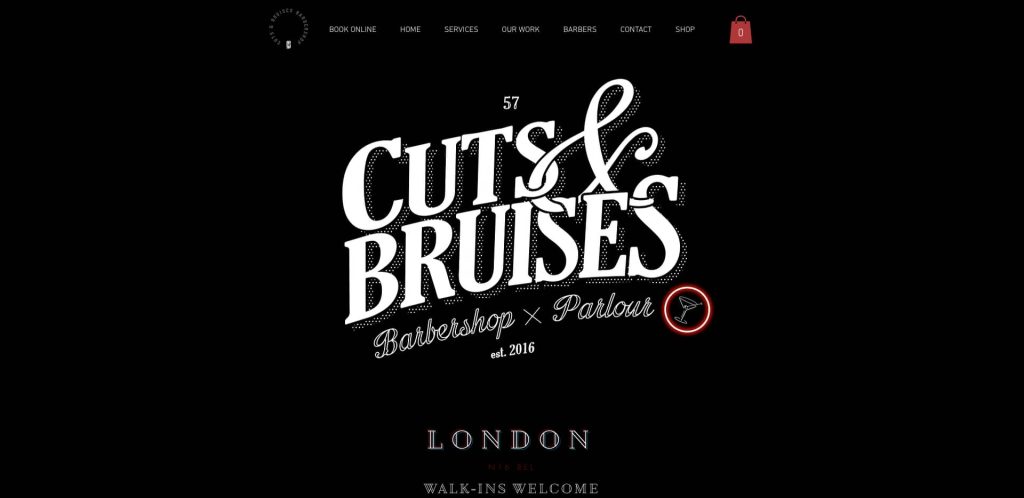 A black webpage with white text reading Cuts & Bruises Barbershop x Parlour est. 2016. A small arrow is circled in red. Lower text says London and Walk-ins Welcome. Menu options are visible at the top.