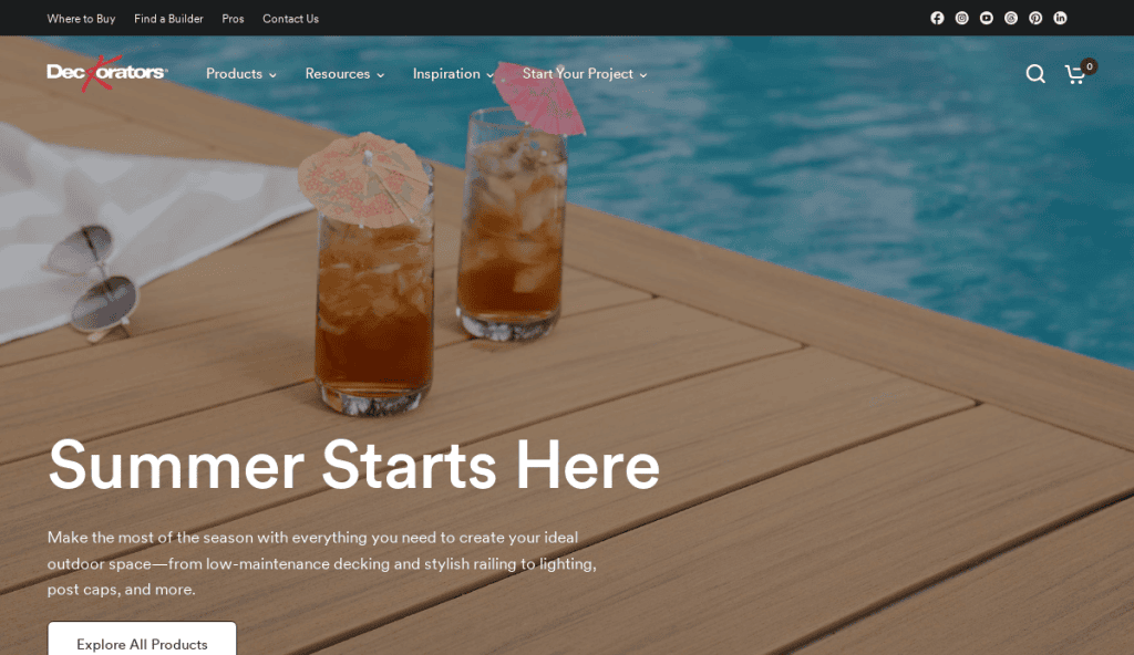 Two iced drinks with umbrellas sit on a wooden deck beside a blue pool. White text reads Summer Starts Here above a button labeled Explore All Products. The scene conveys a relaxing outdoor summer atmosphere.