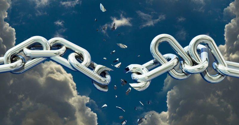 A close-up of a silver chain breaking apart in the sky, with shards flying and dramatic clouds in the background—symbolizing a bold upgrade beyond limits, like moving from WordPress to Squarespace.
