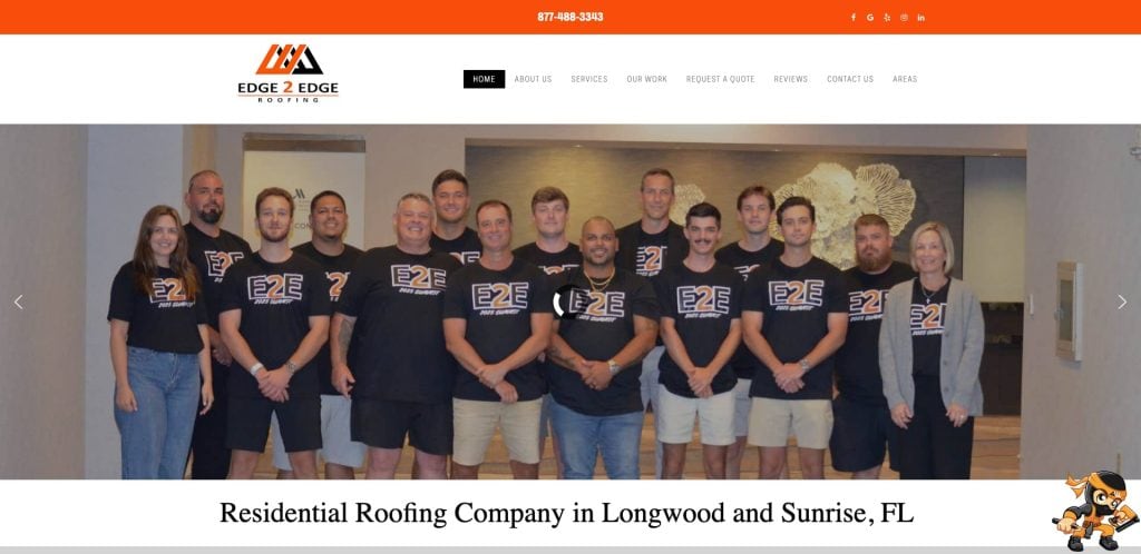 A group of people wearing matching black E2E shirts stands together indoors, smiling for a group photo. The Edge 2 Edge Roofing company logo and contact number appear above them on a website header.
