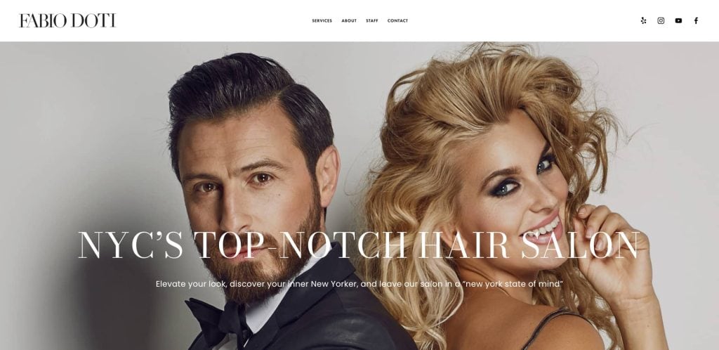 A stylish man in a tuxedo and a smiling woman with voluminous, wavy blonde hair pose together, promoting a New York City hair salon. The text reads “NYC’s Top-Notch Hair Salon.”.
