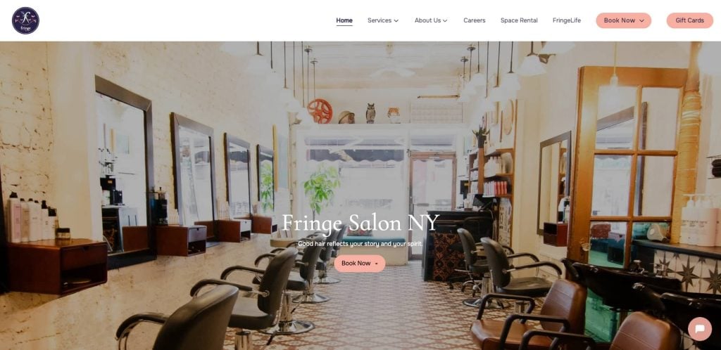 Bright, stylish hair salon interior with mirrors, chairs, and shelves of products. Text overlay reads “Fringe Salon NY” with a menu bar above and buttons for booking and gift cards.