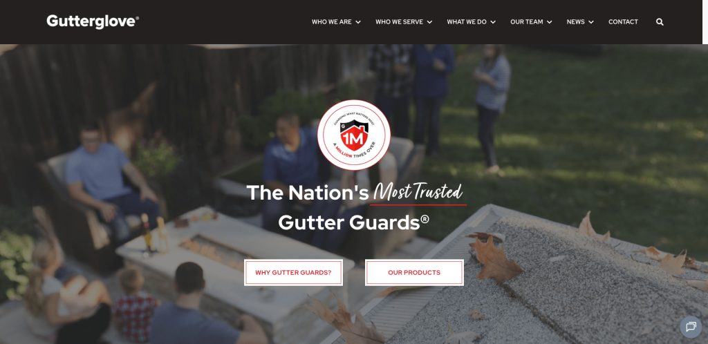 A group of people sits around an outdoor fire table on a patio. The foreground shows a gutter with leaves. Text reads, The Nations Most Trusted Gutter Guards. Buttons say Why Gutter Guards? and Our Products.